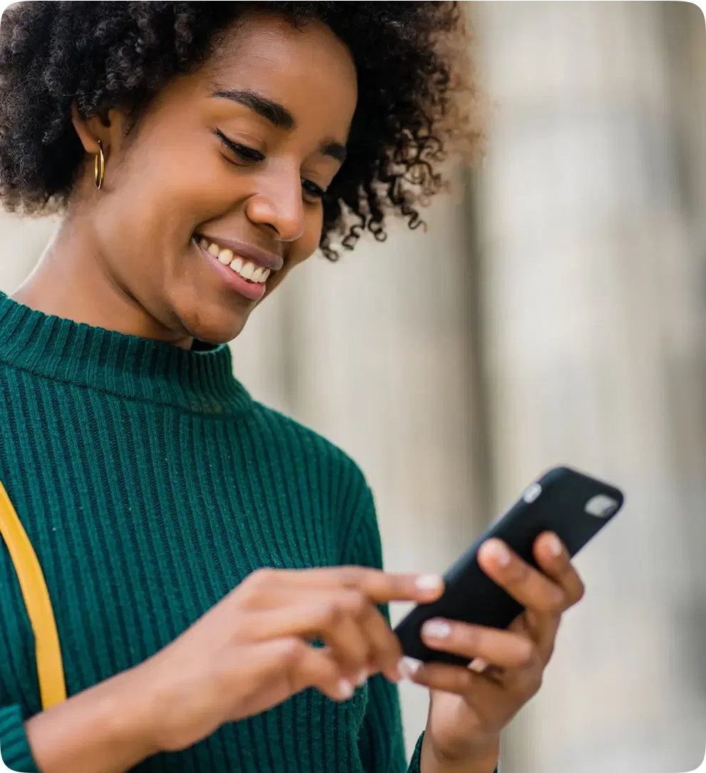 woman smiling at her phone