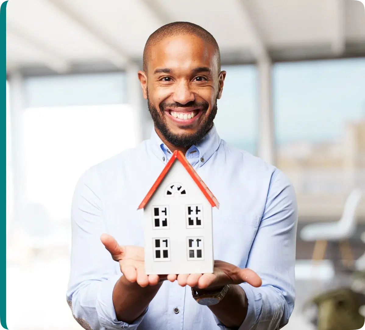 man holding a small house